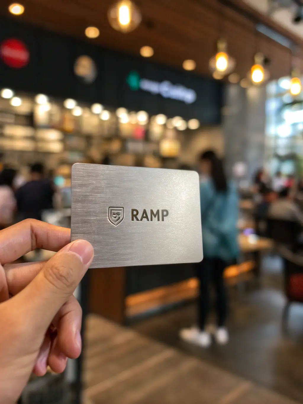 A professional photograph showcasing Ramp's corporate credit card, emphasizing its sleek design and features, placed on a modern office desk with a laptop and financial documents in the background.